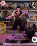 Sculptor's render of the painted design (kit ships unpainted): front view of the giant monk in prayer, the chain looping over his head to the hand axe on one side and the spiked ball on the stone base
