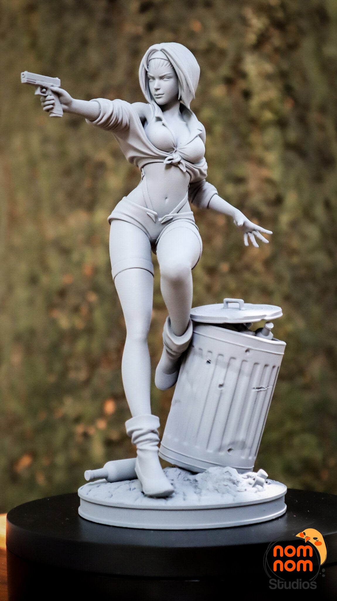 Sculptor's photo of an unpainted print: front three-quarter view of the full figure, pistol arm out, raised boot on the trash can