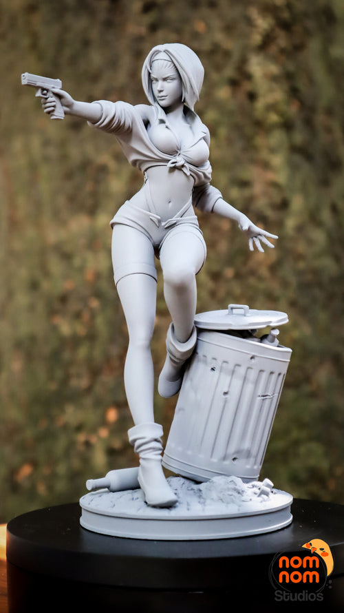Sculptor's photo of an unpainted print: front three-quarter view of the full figure, pistol arm out, raised boot on the trash can