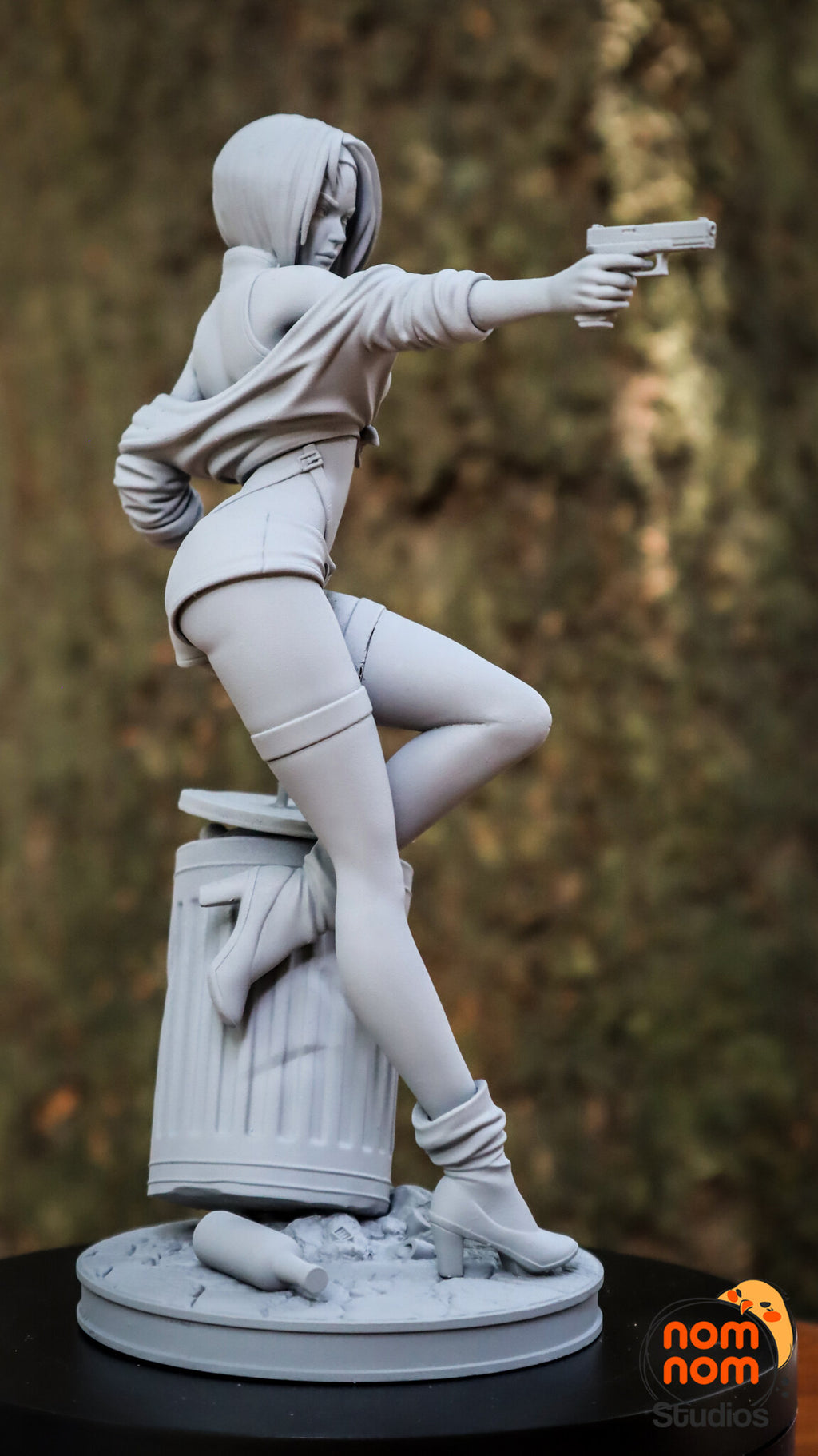 Sculptor's photo of an unpainted print: side view of the raised leg on the trash can and the outstretched pistol arm