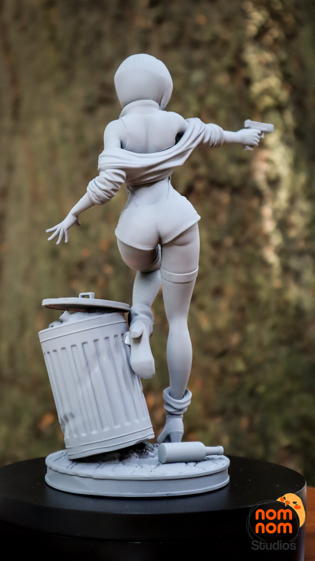 Sculptor's photo of an unpainted print: rear view of the full figure with the jacket off the shoulders, the trash can and the dropped bottle