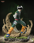 Sculptor's render of the painted design (kit ships unpainted): front three-quarter view of the bowl-cut martial artist in a wide fighting stance, one bandaged hand raised, with sand tendrils sweeping up around him on a cracked green tile base