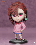 Sculptor's render of the painted design (kit ships unpainted): front view of the chibi auburn-haired girl in a pink sweater and red bow, one hand on her hip, on the round flagstone base