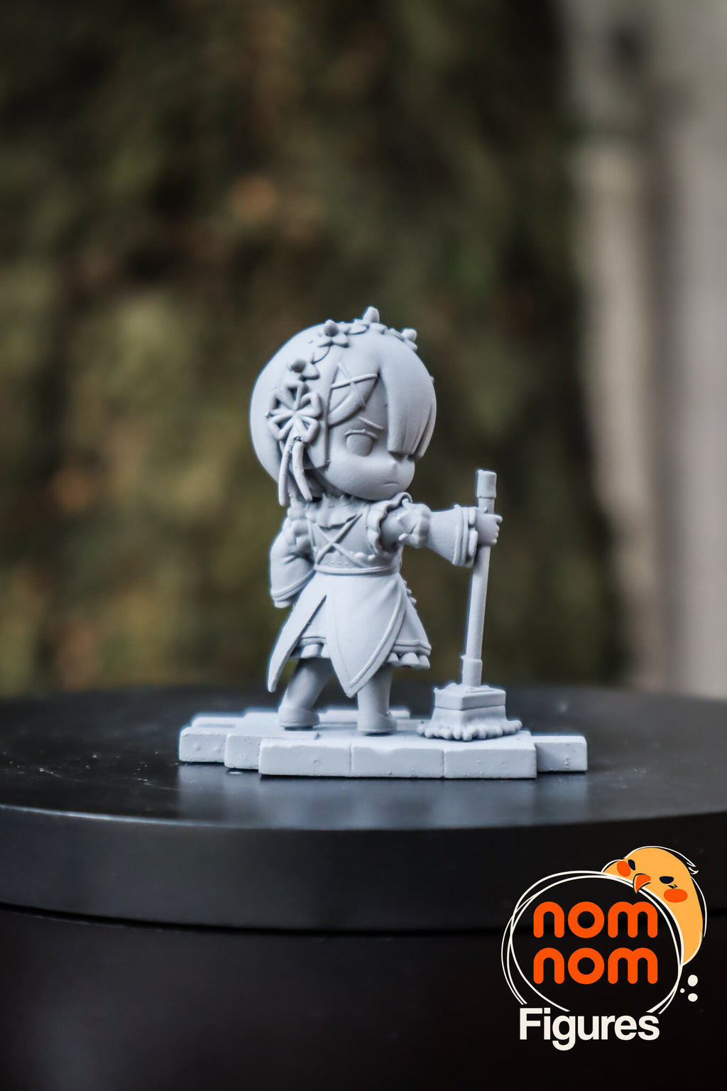 Sculptor's photo of an unpainted print: the twin with the mop on her own tile, from the side