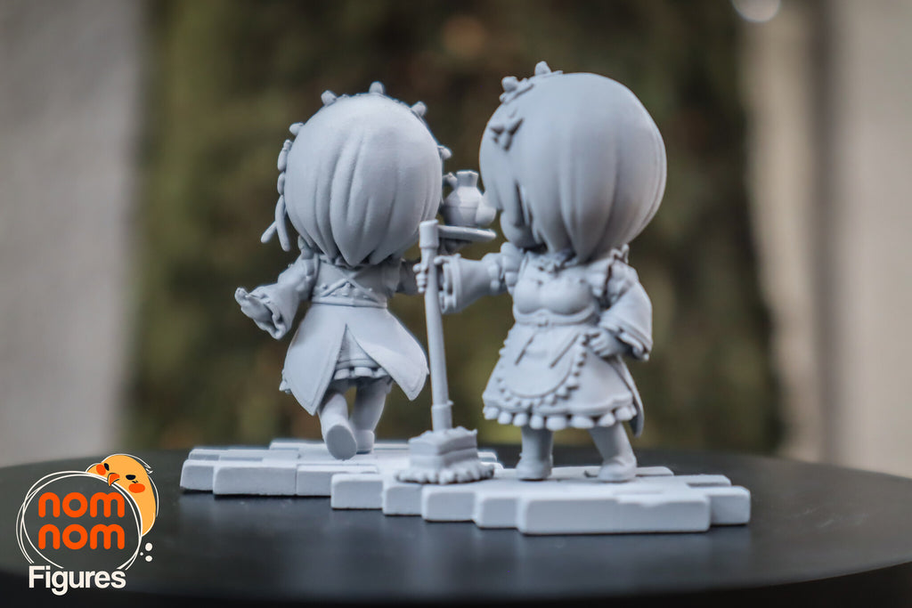 Sculptor's photo of an unpainted print: the pair from behind, the mop standing between them