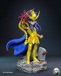 Sculptor's render of the painted design (kit ships unpainted): full front three-quarter view of the chibi gold-armored warrior raising a red lightning star, on a cracked stone base with columns and small scorpions