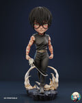 Sculptor's render of the painted design (kit ships unpainted): front full view of the chibi swordswoman in round glasses walking forward on the slate base, curved blade held low, cream flame swirls behind her