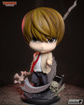 Sculptor's render of the painted design (kit ships unpainted): front view of the chibi in a cream jacket and red tie holding a bone-handled scythe low, its shaft rising behind him, on a slate base with a skull and a black notebook
