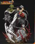 Sculptor's render of the painted design (kit ships unpainted): front three-quarter view of the 1:10 statue, the warrior monk with his axe raised and prayer beads in his open hand, the chain and spiked ball looping around him above the rubble and thorn base