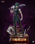 Sculptor's render of the painted design (kit ships unpainted): front view of the swordswoman in round glasses with the heavy blade on her shoulder and the empty-hand left arm, standing on the wrecked tatami room base