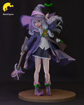 Sculptor's render of the painted design (kit ships unpainted): front view of the silver-haired witch touching the brim of her wide hat, holding a wrapped broom, on a round paved base