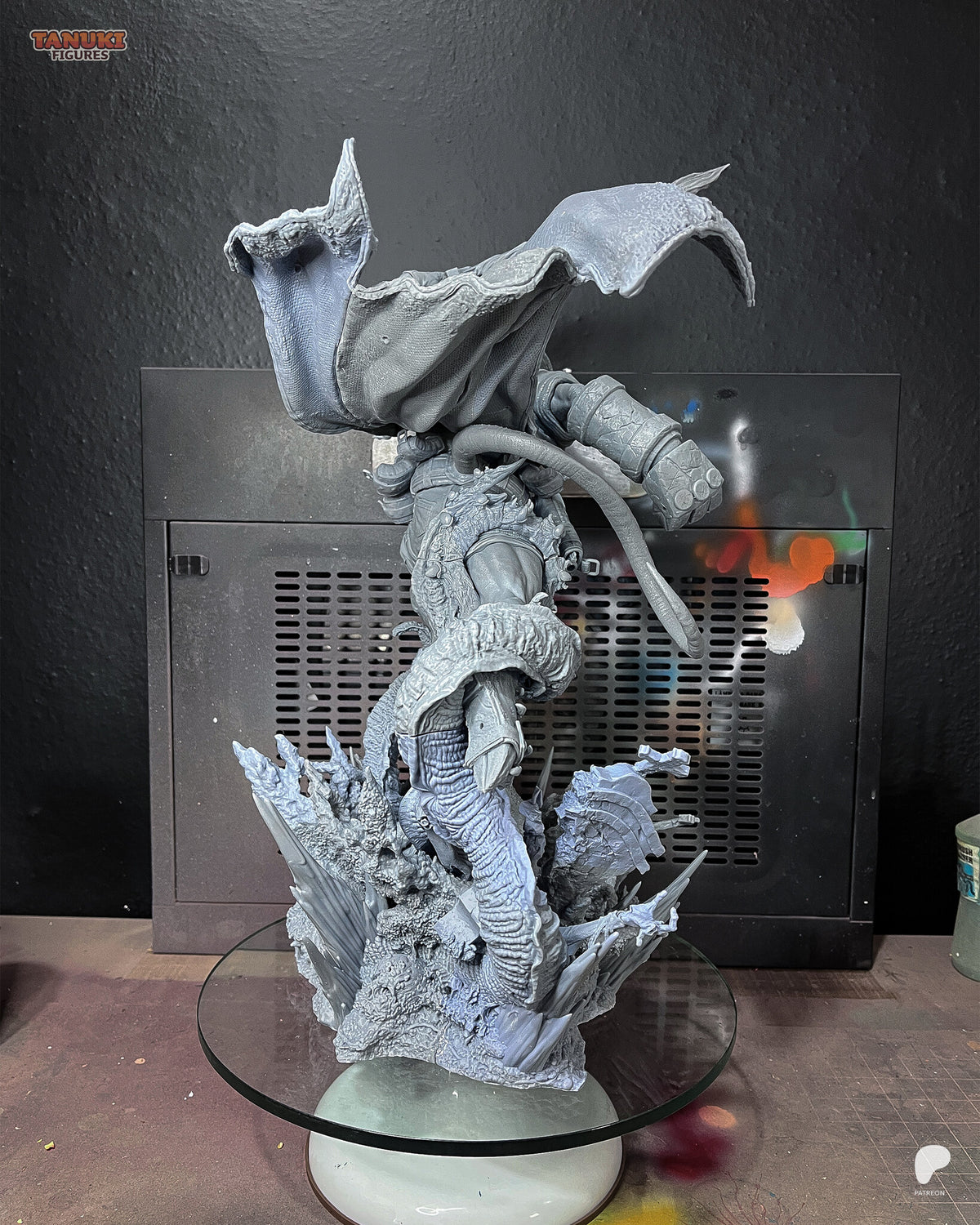 Studio photo of the unpainted test print (kit ships unpainted): rear view showing the underside of the flying coat and the serpent neck holding him up