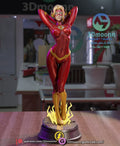 Sculptor's render of the painted design (kit ships unpainted): front view of the heroine in the red bodysuit, hands behind her head, standing in a lightning burst on the round plinth