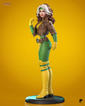 Sculptor's render of the painted design (kit ships unpainted): full view of the toon-style heroine on a round base in a cropped brown leather jacket, green-and-yellow suit and yellow thigh-high boots, one gloved fist raised