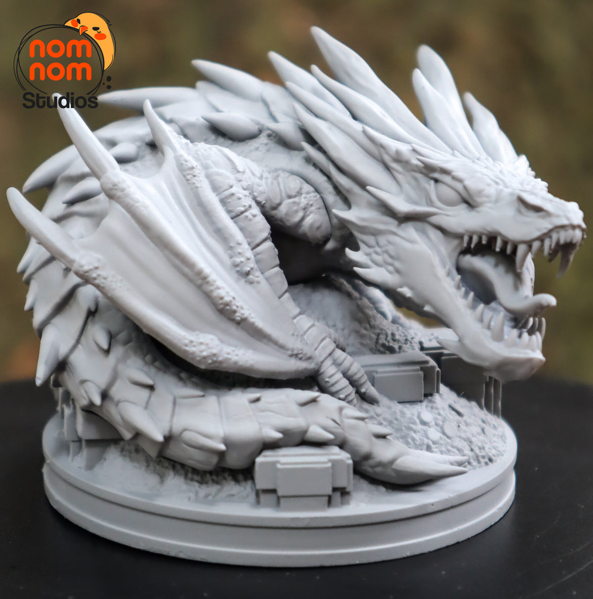 Sculptor's photo of an unpainted print: front three-quarter view with the tongue curling out and the spiked tail across the front of the base