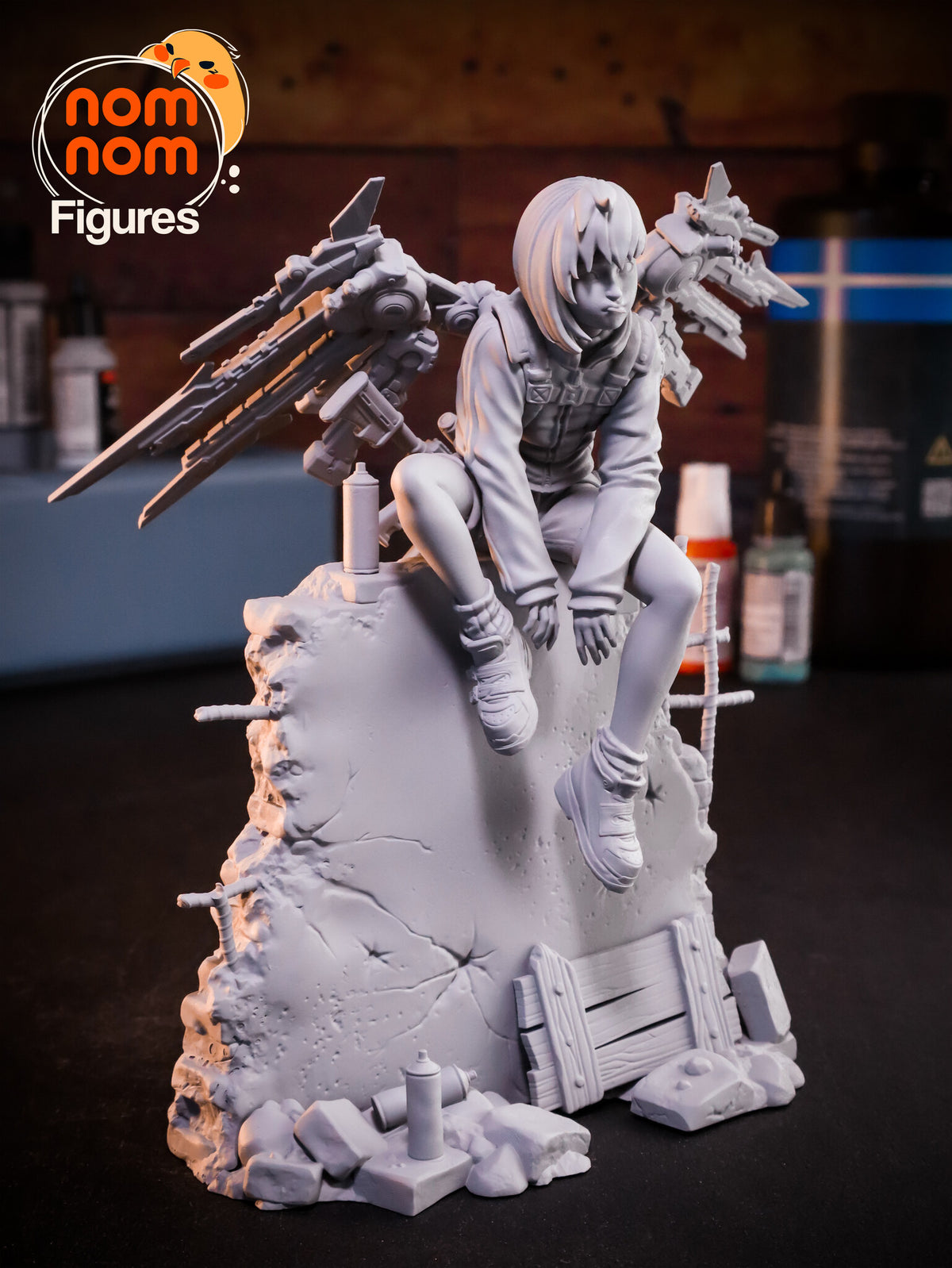 Sculptor's photo of an unpainted print: front three-quarter view showing the plank barricade, the rubble and the spray cans