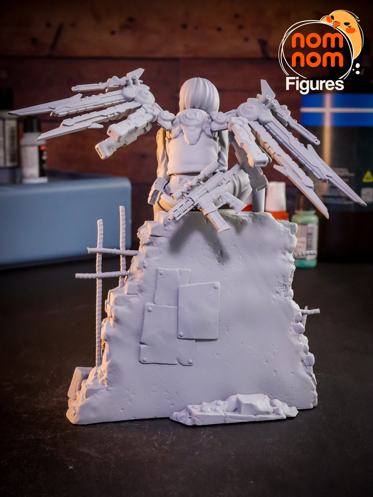 Sculptor's photo of an unpainted print: straight rear view of the wing mount, both wings spread and the rifle across the wall top