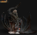 Sculptor's render of the painted design (kit ships unpainted): front view of the black dragon wrapped around the ruined stone tower, wings spread and tail arched overhead