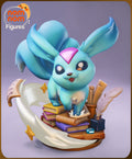 Sculptor's render of the painted design (kit ships unpainted): the teal long-eared creature with a pink forehead gem standing on a stack of colored books, a white paper ribbon curving around the base