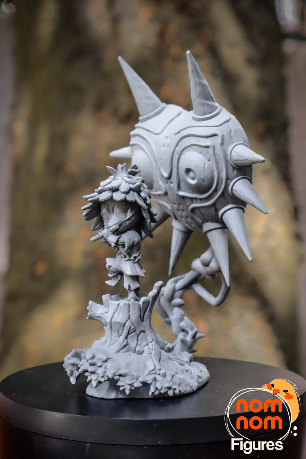 Sculptor's photo of an unpainted print: three-quarter view from the other side, the imp on the stump in front of the mask